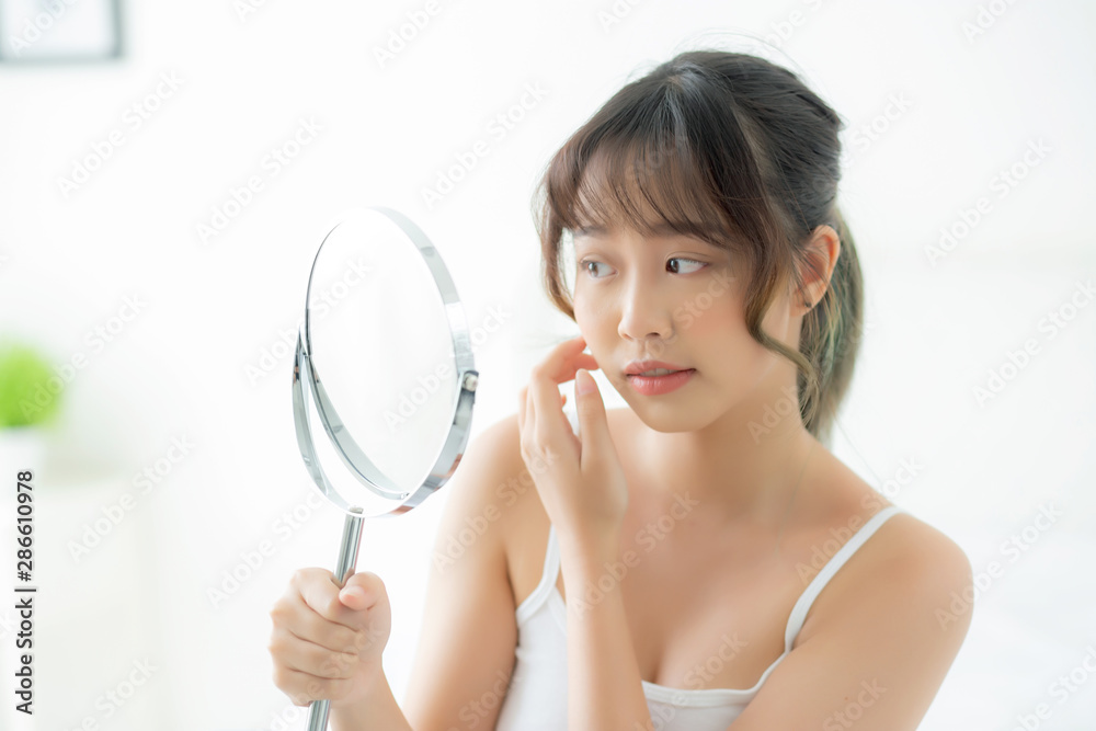 Beautiful face young asian woman with happy smiling and looking mirror, makeup of beauty facial girl with skincare and cosmetic treatment, refresh of female and clean for charming, healthy concept. Beautiful face young asian woman with happy smiling and looking mirror, makeup of beauty facial girl with skincare and cosmetic treatment, refresh of female and clean for charming, healthy concept.