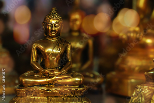 background of golden buddha statue with bokeh