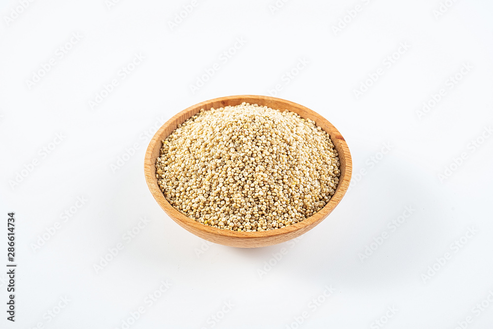 A wooden bowl of miscellaneous grains buckwheat on a white background A wooden bowl of miscellaneous grains buckwheat on a white background
