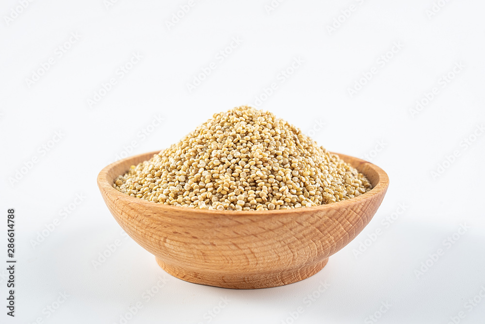 A wooden bowl of miscellaneous grains buckwheat on a white background A wooden bowl of miscellaneous grains buckwheat on a white background