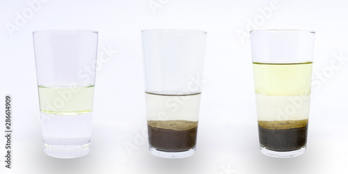 фотографія Science experiment: heterogeneous mixture of water, oil and sand; water and oil; water and sand