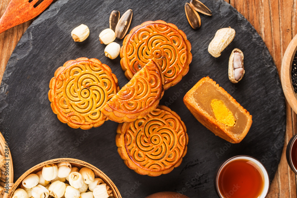 Fototapeta premium Traditional mooncakes on table setting with teacup.