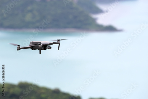 Drones while flying in the sky  Ocean and island backgrounds.