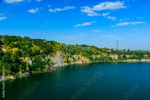 Beautiful lake in the abandoned granite quarry on summer