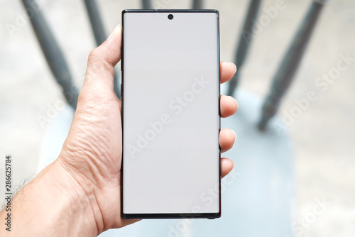  The man's hand is holding a New smartphone.