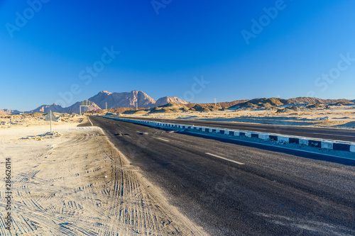 Asphalt road in arabian desert not far from the Hurghada city, Egypt