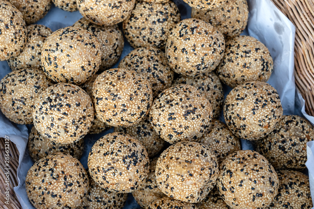 Coconut rice balls with sesame seeds is traditional Thai dessert made from rice flour and coconut milk at street food market in Thailand