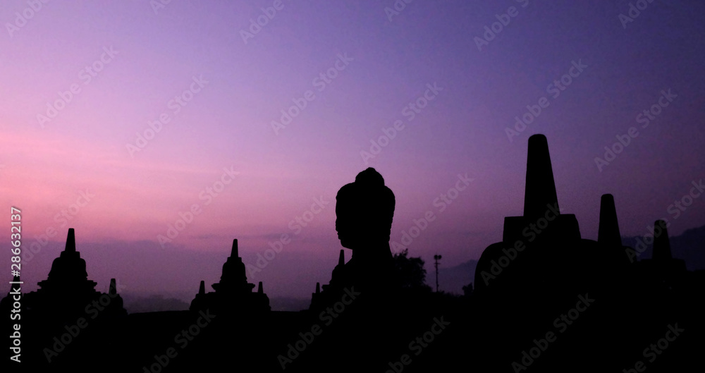Fototapeta premium Natural amazing sunrise view at Borobudur Buddhist temple, great religious architecture in Magelang, Central Java, Indonesia.