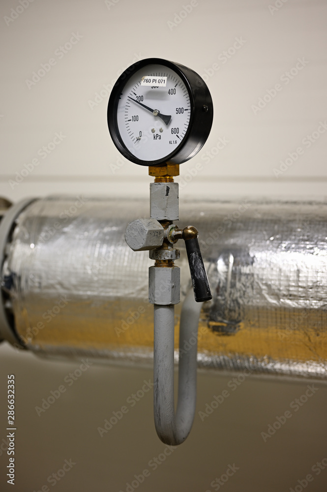 Analog pressure indicator circular on pipe. Stock Photo | Adobe Stock