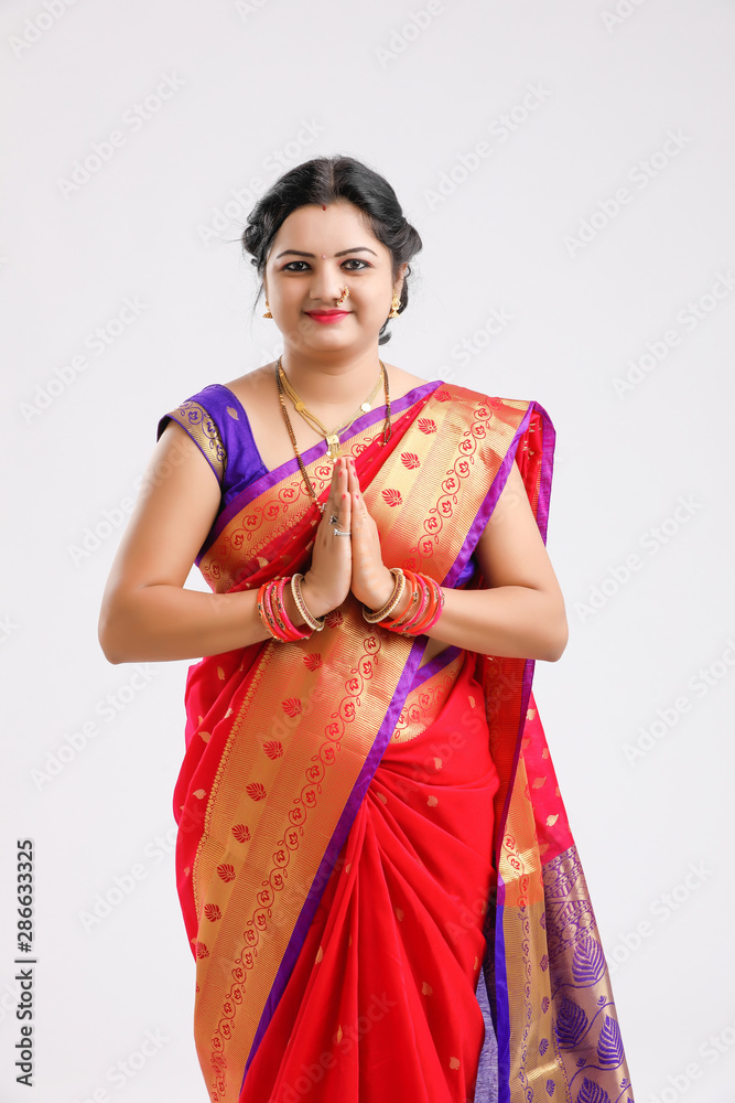 young Indian woman wearing Sari and showing a welcome gestures, isolated on white background young Indian woman wearing Sari and showing a welcome gestures, isolated on white background