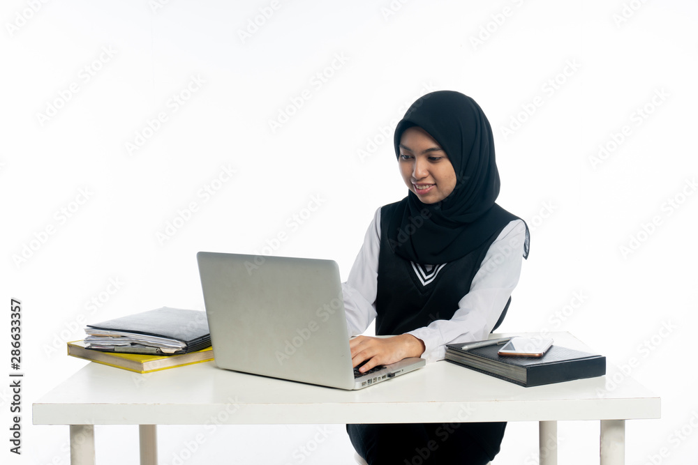 Happy cheerful asian woman working on laptop computer Happy cheerful asian woman working on laptop computer