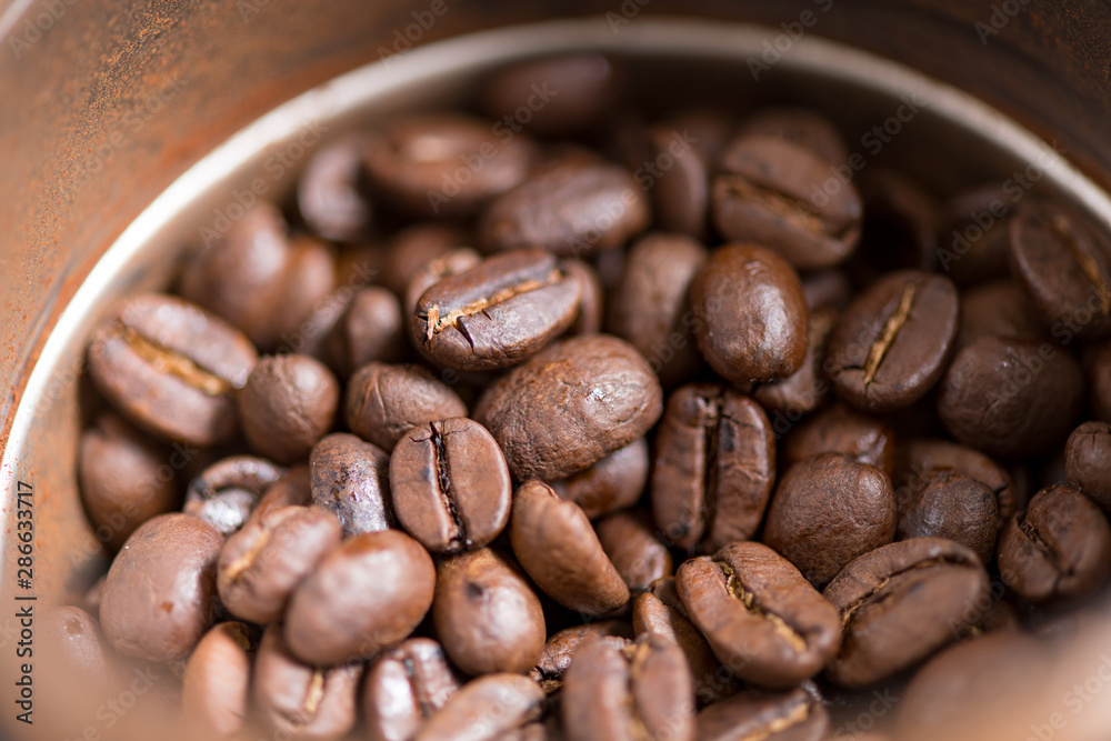 Coffee beans are ground into coffee powder by a grinder. Coffee beans are ground into coffee powder by a grinder.