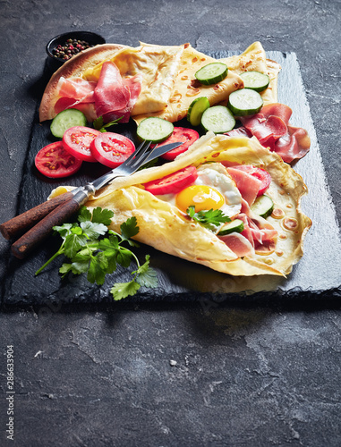 Crepes with fillings of egg, ham, vegg photo