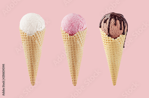 Set of classic flavor ice cream cones in waffle cone - white, pink, brown with chocolate sauce on pink background.
