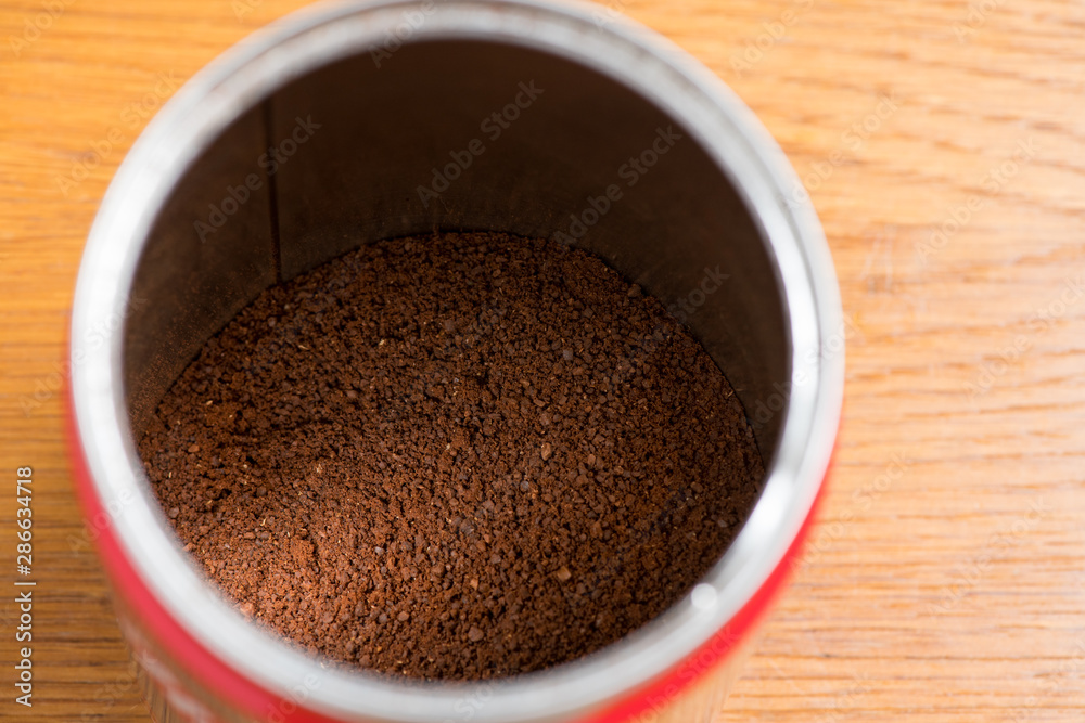 Coffee beans are ground into coffee powder by a grinder. Coffee beans are ground into coffee powder by a grinder.
