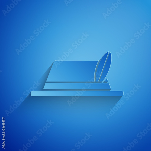 Paper cut Oktoberfest hat icon isolated on blue background. Hunter hat with feather. German hat. Paper art style. Vector Illustration