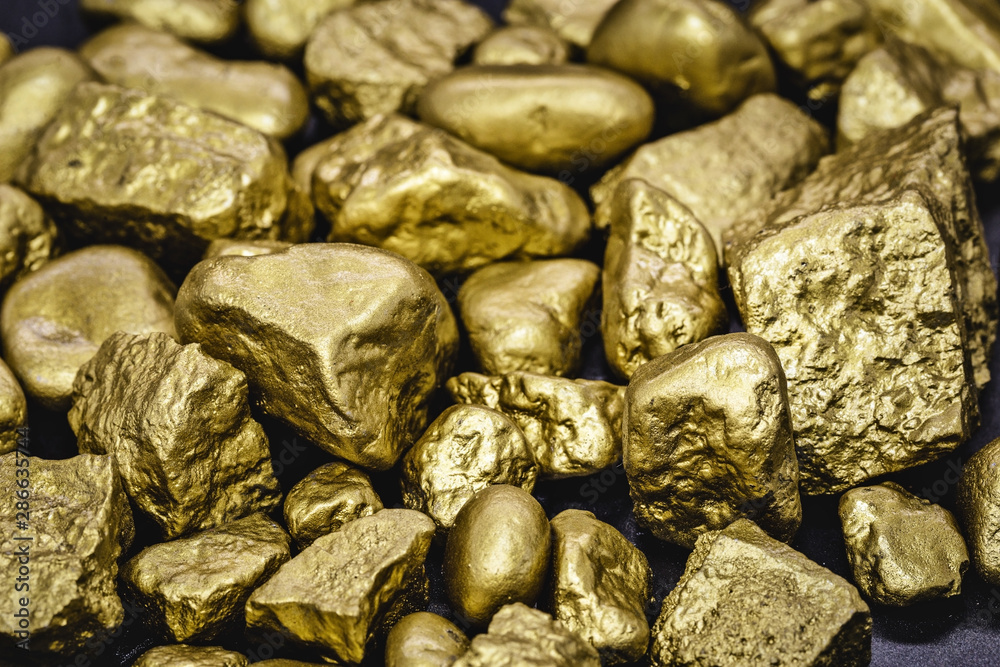 Golden nuggets isolated on black background. Luxury concept and gold. Golden nuggets isolated on black background. Luxury concept and gold.
