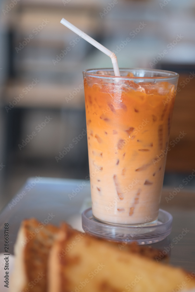 Thai milk tea in glass with straw Thai milk tea in glass with straw