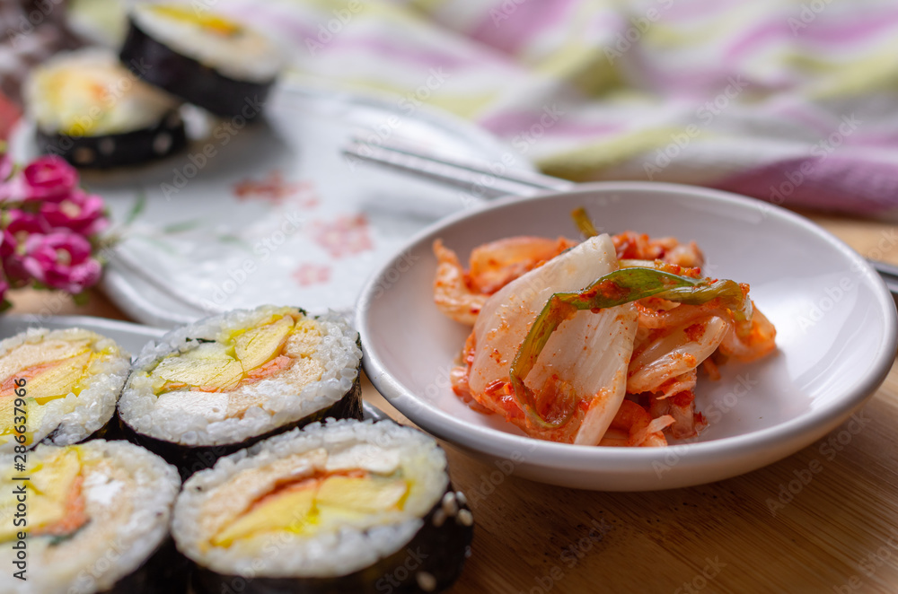 Kimchi and Gimbap serving on white plate Kimchi and Gimbap serving on white plate