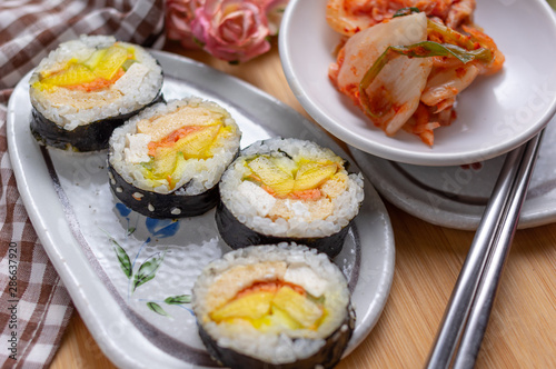 Kimchi and Gimbap serving on white plate