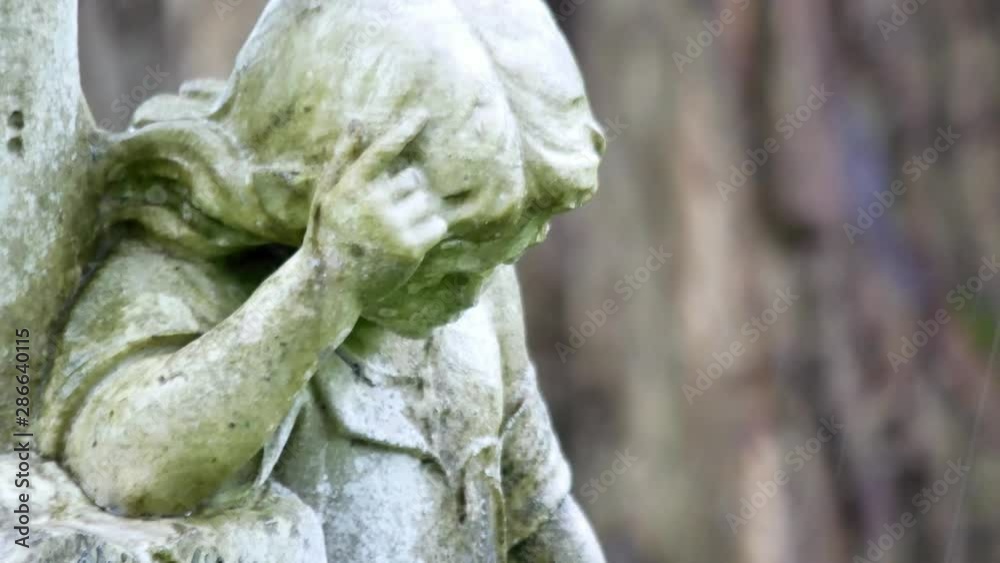 Angel girl stone grave headstone in rainy cemetery. Sad, mourning, sorrow remembrance figure. Angel girl stone grave headstone in rainy cemetery. Sad, mourning, sorrow remembrance figure.