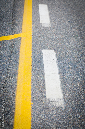 white and yellow road marking on street