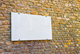 Blank marble plaque on stone wall - image with copy space