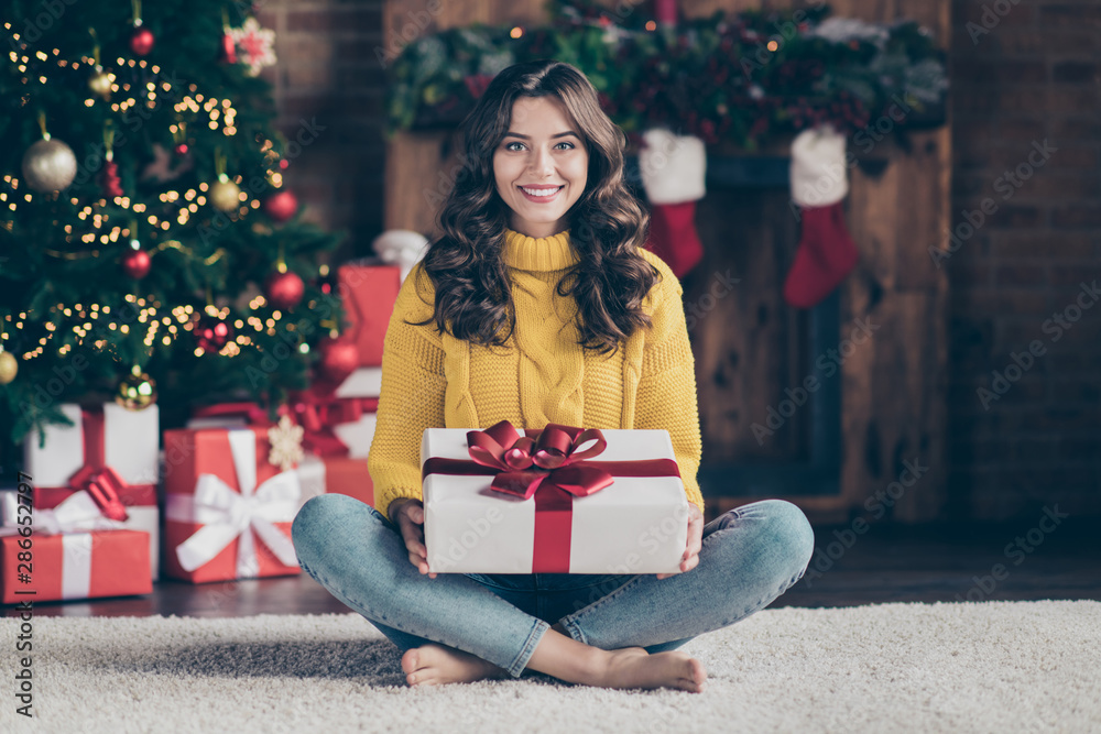 Full length body size photo of cheerful cute nice beautiful attractive girl admiring her present while sitting on floor carpet wearing jeans denim