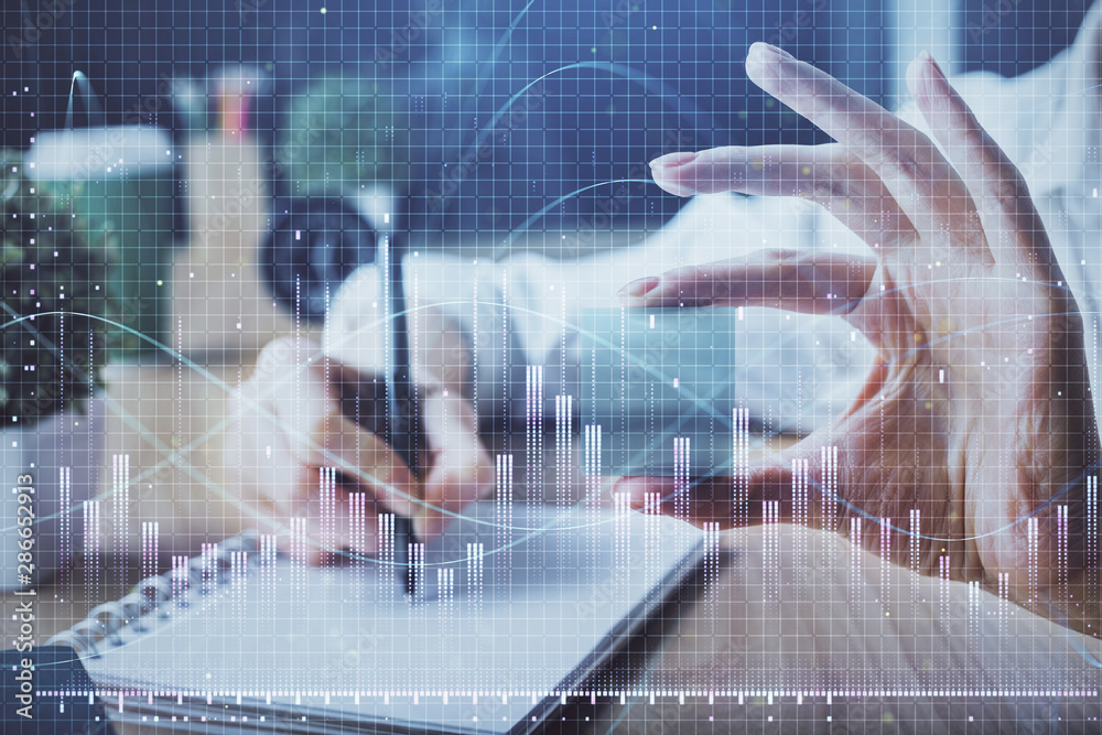 Forex chart displayed on woman's hand taking notes background. Concept of research. Multi exposure Forex chart displayed on woman's hand taking notes background. Concept of research. Multi exposure