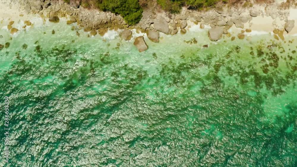 White sandy beach and azure water of the lagoon,copy space for text, top view. Ocean with waves and tropical beach. Summer and travel vacation concept White sandy beach and azure water of the lagoon,copy space for text, top view. Ocean with waves and tropical beach. Summer and travel vacation concept