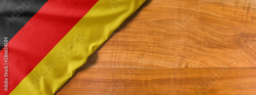National flag of Germany on a wooden background with copy space