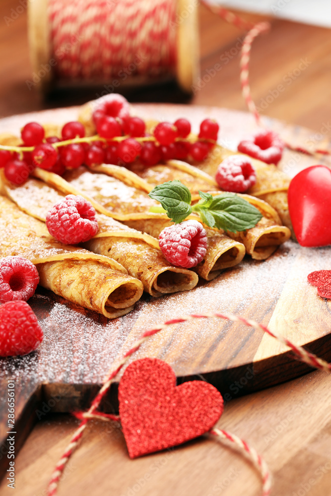Delicious Tasty Homemade crepes or pancakes with raspberries and mint on rustic background Delicious Tasty Homemade crepes or pancakes with raspberries and mint on rustic background