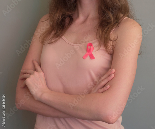 Wallpaper Mural Pink ribbon closeup on the woman chest, breast cancer, October awareness month. Medicine and healthcare concept. Torontodigital.ca