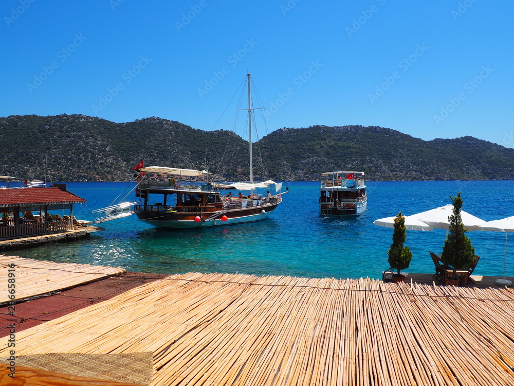 Two travel boats on the port of Kalekoy village in Kekova Gulf, where is a popular touristic destination in the south of Turkey.