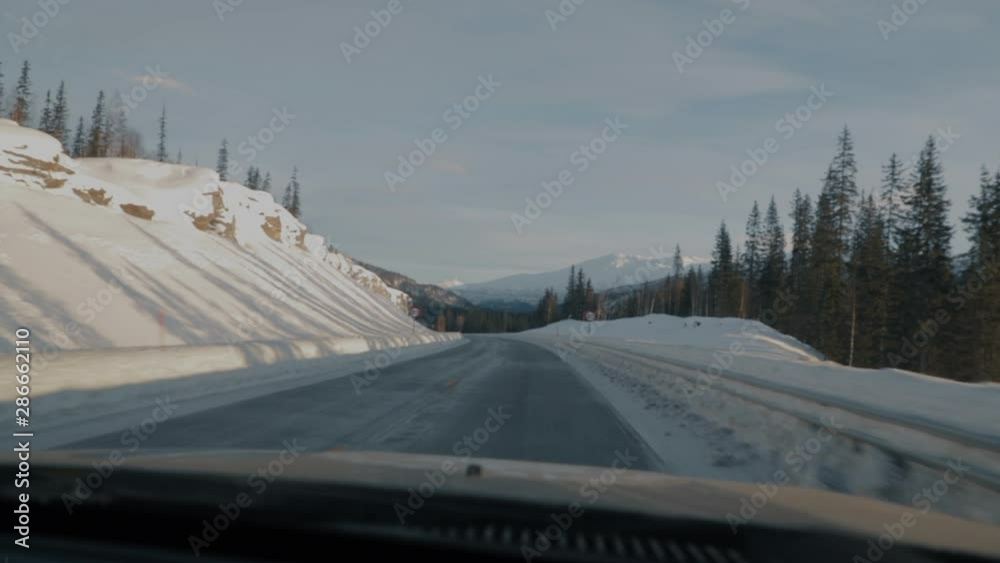 View through windshield of car driving in Polar Circle, Norway during day. View through windshield of car driving in Polar Circle, Norway during day.