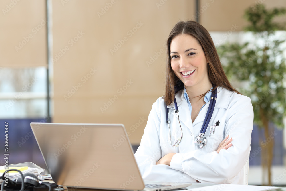 Happy doctor posing looking at camera at consultation Happy doctor posing looking at camera at consultation