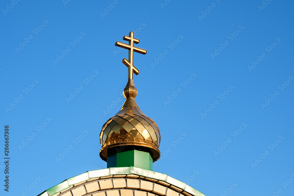 dome of the Orthodox Church with a cross against the blue sky dome of the Orthodox Church with a cross against the blue sky