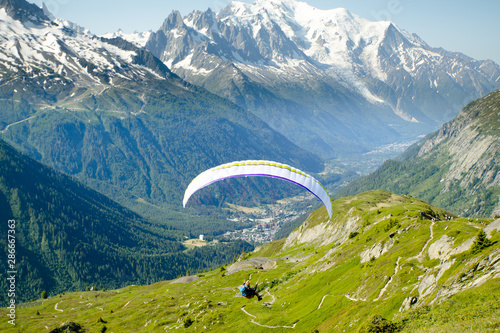 A paraglider flying towards Mont Blanc in the Chamonix Valley
