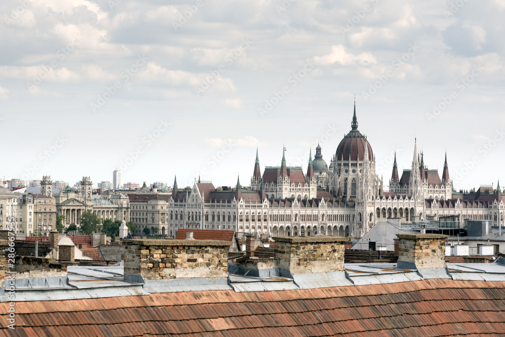 Fototapeta premium Hungarian Parliament in Budapest, view over a house roof