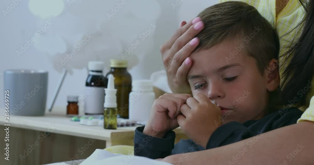 Mother with her little sick son in bedroom Mother with her little sick son in bedroom