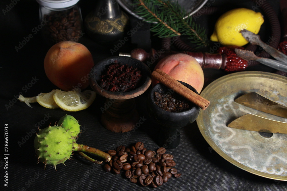 bowl with tobacco for hookah. fruits on a dark background. smoking sheesha