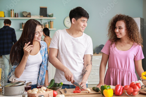 Happy friends cooking toget...