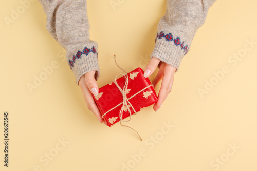 Top view of woman hands holding gift box