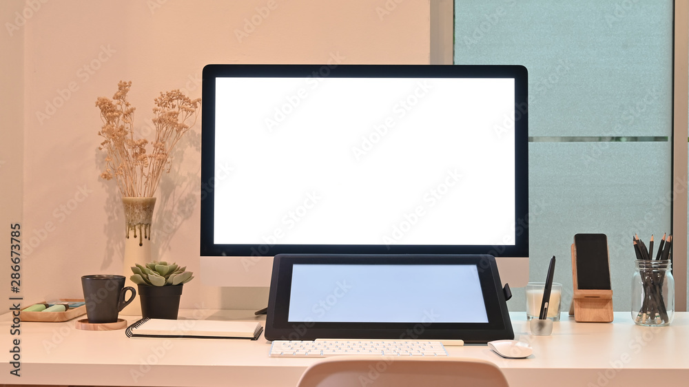 Mockup tablet and computer on creative workspace with warm light. Mockup tablet and computer on creative workspace with warm light.