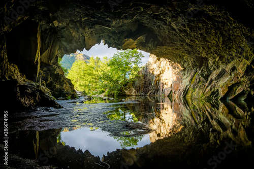 Rydal Cave during golden hour with tree lit up at cave mouth, lake district, UK