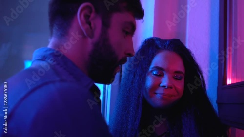 Drunk couple laughing and talking at party, night lifestyle, youth relax, fun