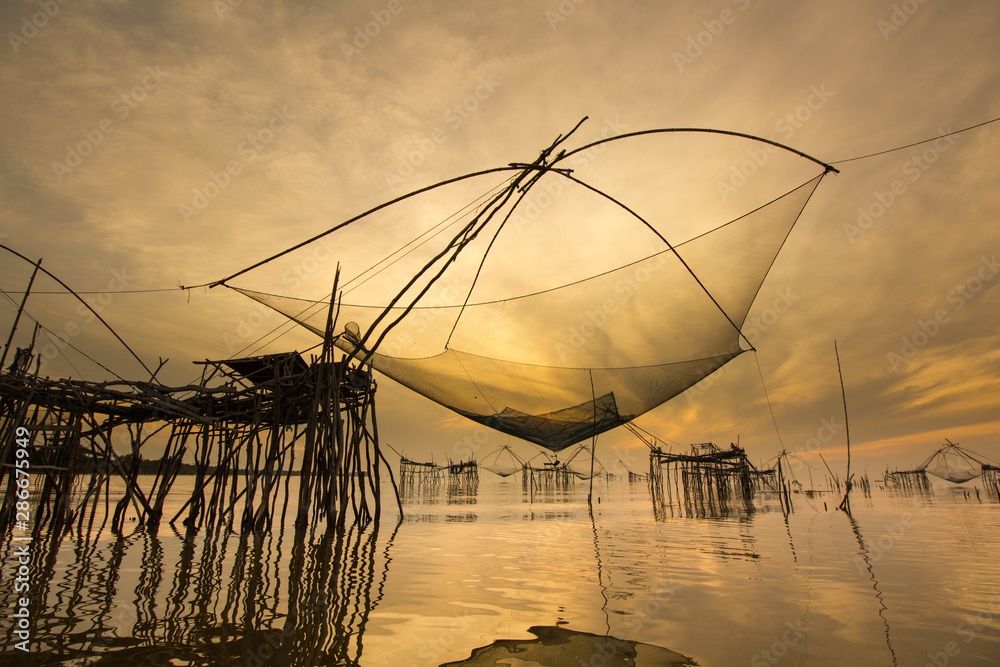 Amazing Thailand. The giant lift net in Phatthalung province still be use for fishing local during travel with long tail boat at sunrise in the the morning 