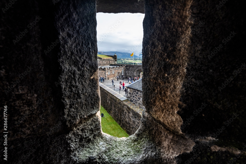 Looking through window at Stirling Castle with tourists and people, Stirling, Scotland, UK