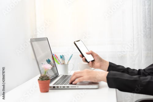 hand hold smartphone on workspace table