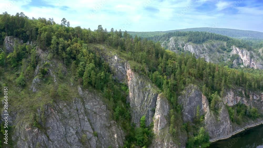 Shooting around the cliff in the early morning. Beautiful view of the mountain range and at the foot of the river. Valley of the forest. Shooting around the cliff in the early morning. Beautiful view of the mountain range and at the foot of the river. Valley of the forest.